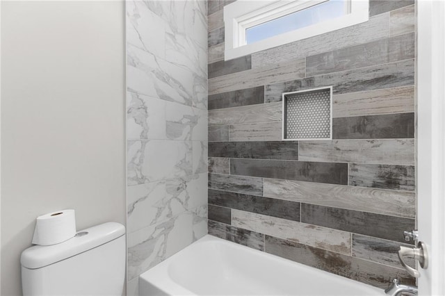 bathroom with toilet and washtub / shower combination