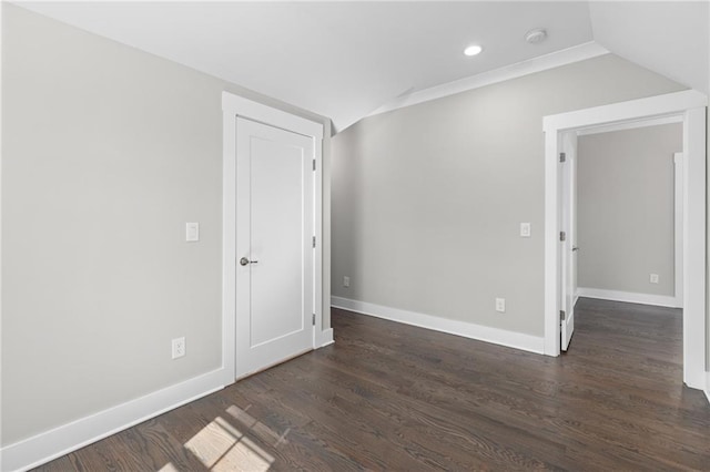 spare room with recessed lighting, baseboards, wood finished floors, and vaulted ceiling