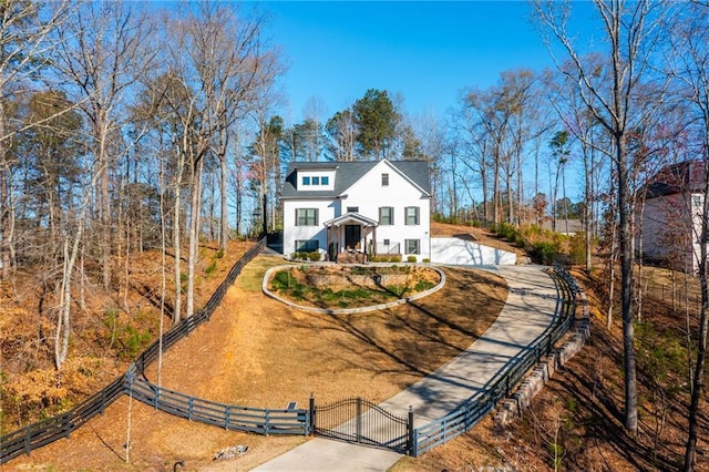 view of front of home with a gate, driveway, and a fenced front yard