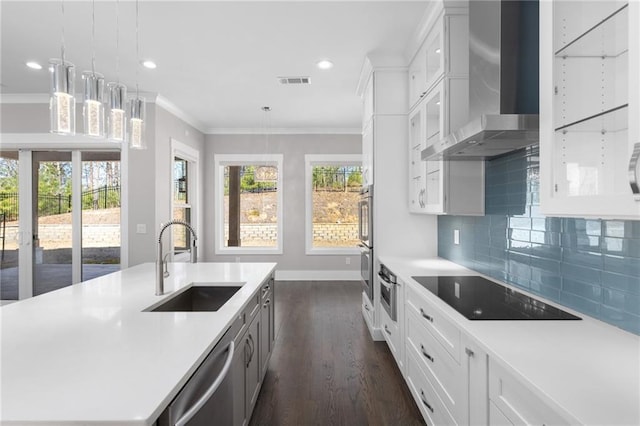 kitchen with visible vents, a sink, light countertops, appliances with stainless steel finishes, and wall chimney exhaust hood