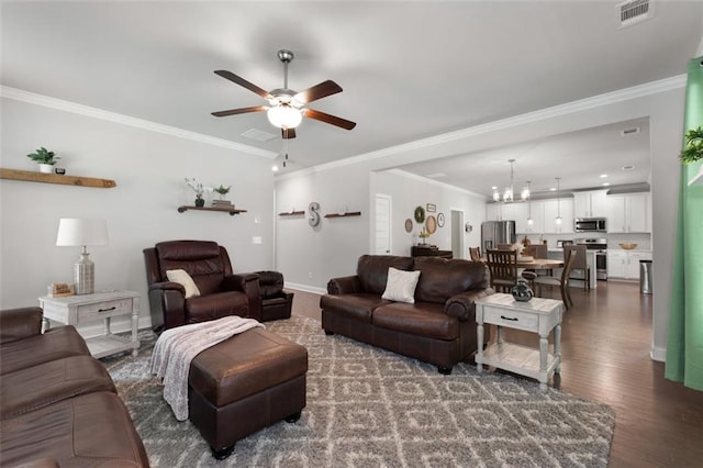 living room featuring dark hardwood / wood-style flooring, crown molding, and ceiling fan with notable chandelier