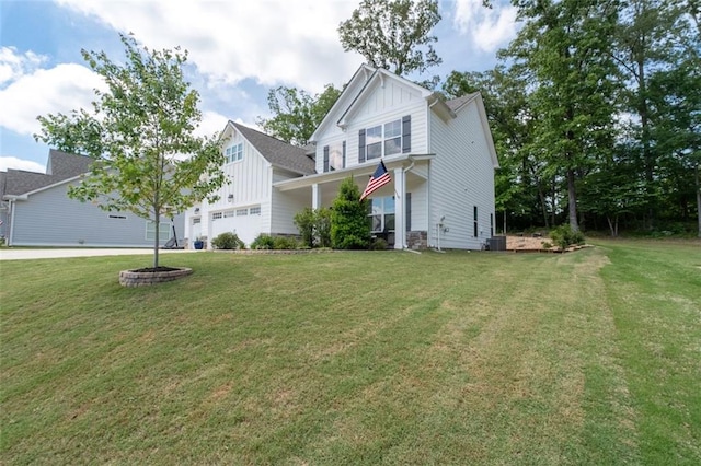 view of front of home with a garage, central air condition unit, and a front yard