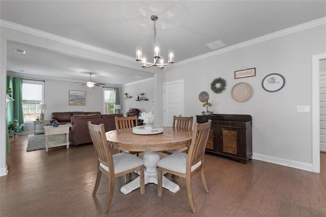 dining area featuring ornamental molding, ceiling fan with notable chandelier, plenty of natural light, and dark wood-type flooring