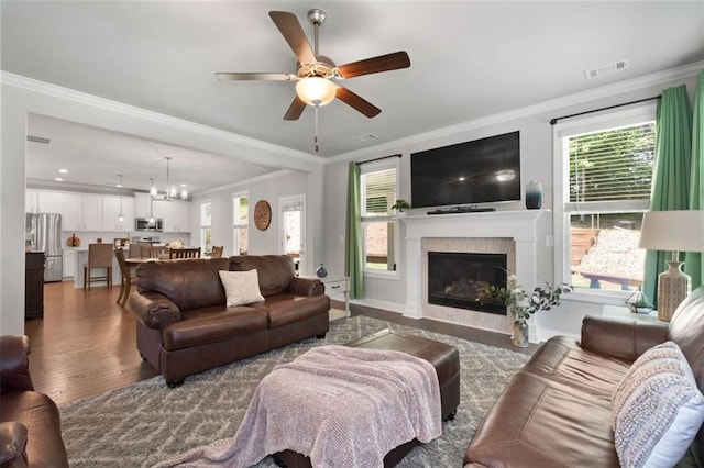 living room with a wealth of natural light and ornamental molding