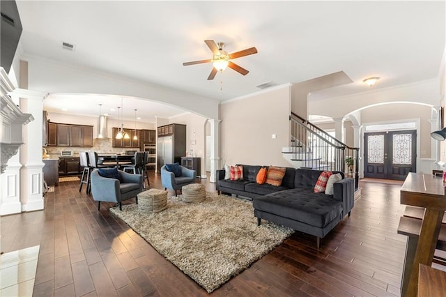 living room featuring crown molding, dark hardwood / wood-style floors, decorative columns, and french doors