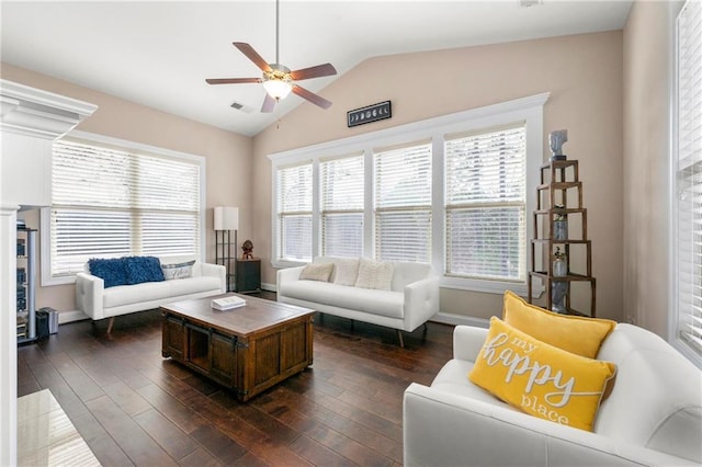 living room featuring dark wood-type flooring, ceiling fan, and vaulted ceiling