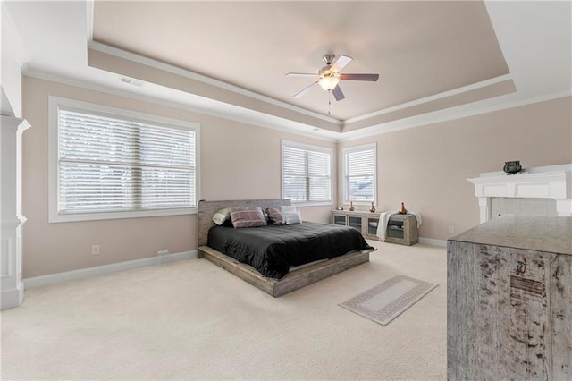 bedroom with carpet floors, ornamental molding, a raised ceiling, and ceiling fan