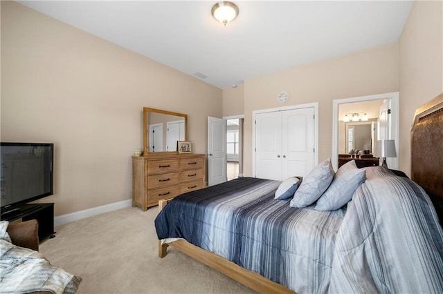 bedroom with light colored carpet and a closet