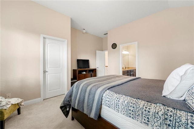 carpeted bedroom featuring connected bathroom