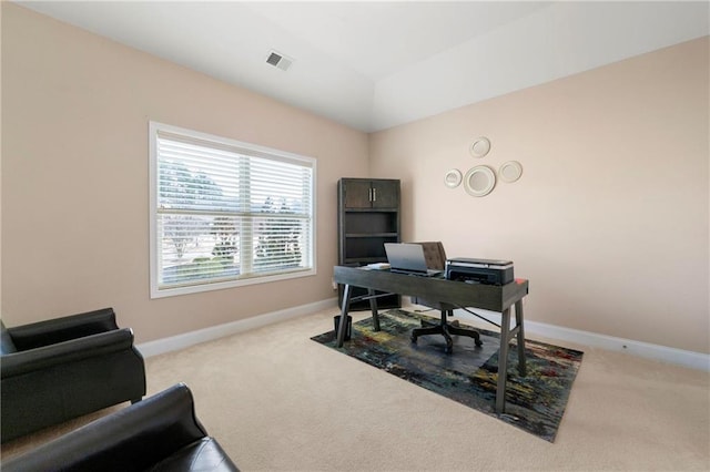 office area with vaulted ceiling and light carpet