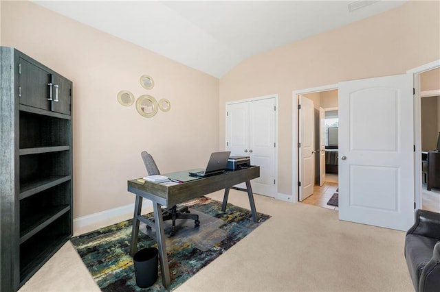 carpeted home office with lofted ceiling