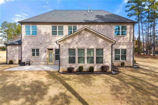 back of property featuring a patio area and a lawn