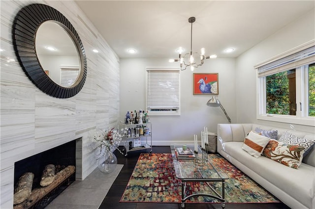 living room featuring tile walls, dark wood-type flooring, and a notable chandelier