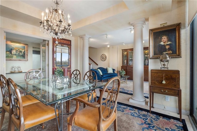 tiled dining room featuring a raised ceiling and decorative columns