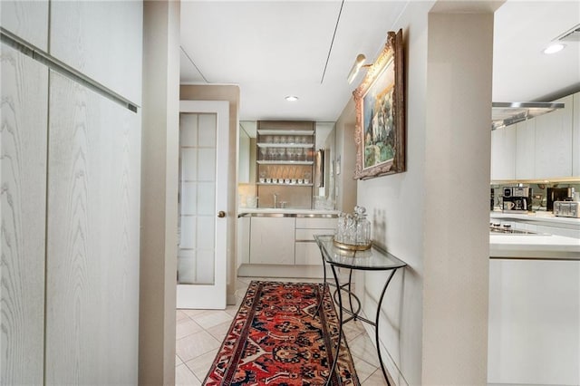 hall featuring light tile patterned floors and recessed lighting