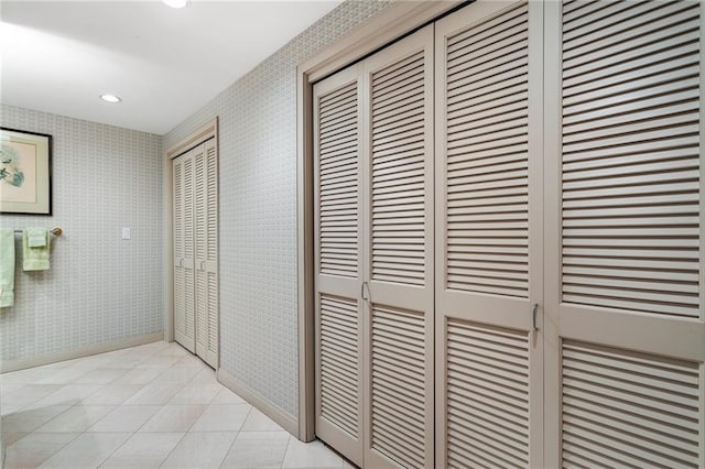 hall featuring wallpapered walls, light tile patterned flooring, baseboards, and recessed lighting