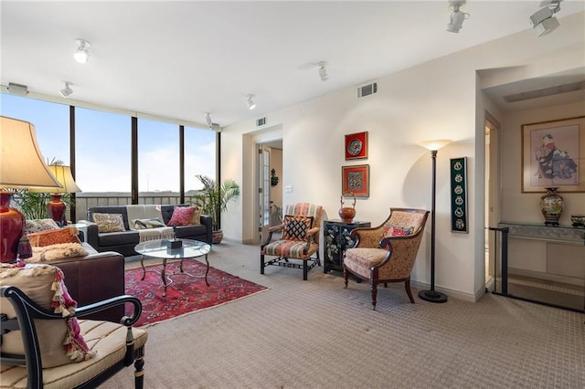 carpeted living room with visible vents and baseboards