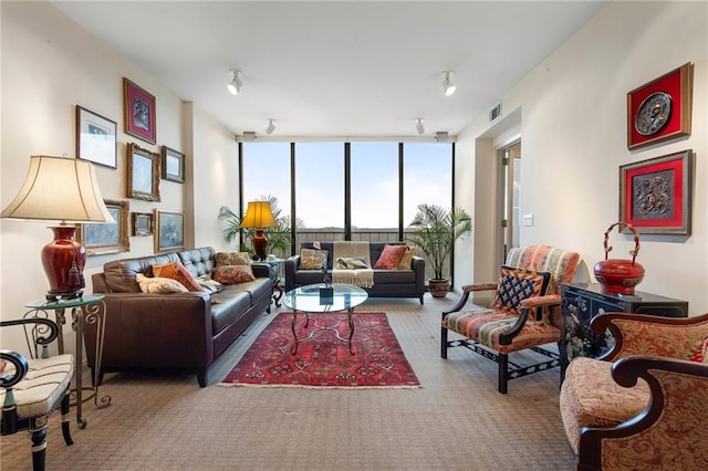 living room featuring carpet, expansive windows, and visible vents