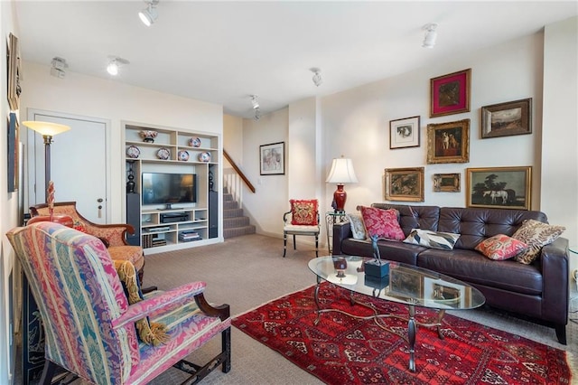 carpeted living room with stairs