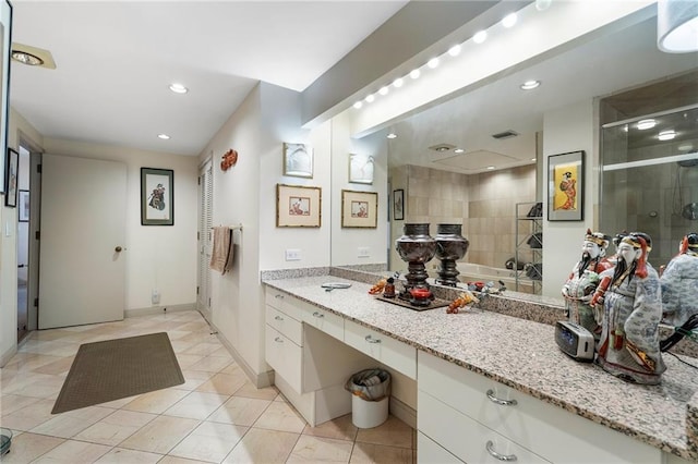 bathroom with a stall shower, baseboards, tile patterned flooring, vanity, and recessed lighting