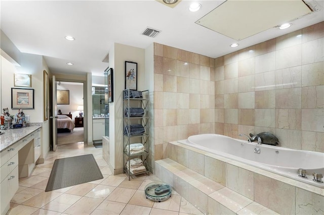 ensuite bathroom featuring ensuite bathroom, tile patterned flooring, a garden tub, visible vents, and tile walls