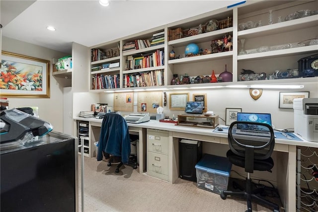 home office featuring recessed lighting, light colored carpet, and built in desk