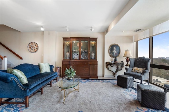 living room with stairs and visible vents