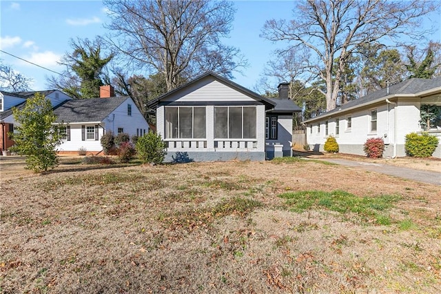 exterior space with a yard and a sunroom