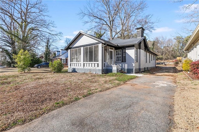 view of front of home featuring a sunroom