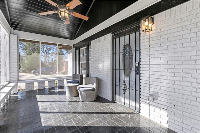 unfurnished sunroom featuring vaulted ceiling and ceiling fan