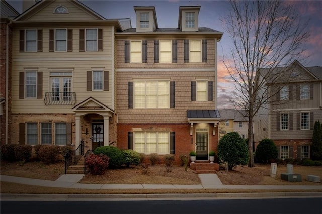 view of front of home featuring brick siding