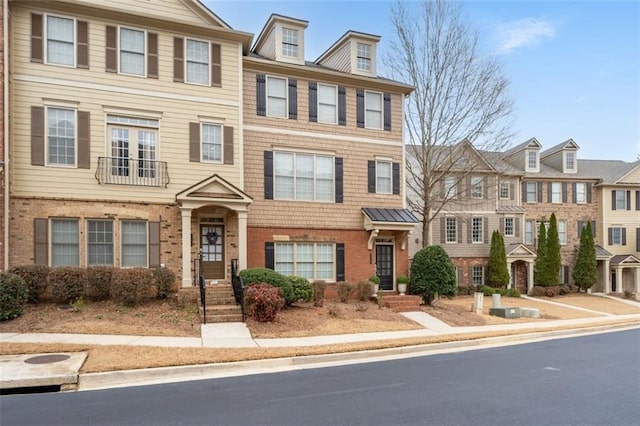 townhome / multi-family property featuring brick siding