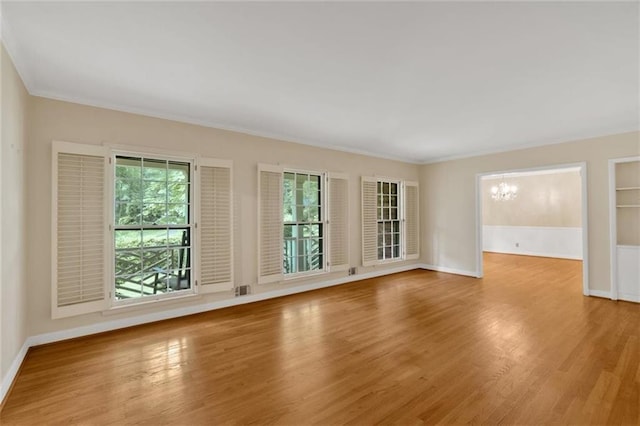 1618 Mason Mill Rd NE, Atlanta, GA 30329 - unfurnished room featuring a chandelier, light wood-style floors, and crown molding