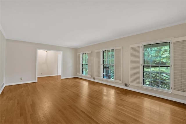 1618 Mason Mill Rd NE, Atlanta, GA 30329 - unfurnished room featuring wood finished floors, healthy amount of natural light, and crown molding