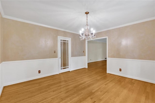 1618 Mason Mill Rd NE, Atlanta, GA 30329 - spare room featuring a chandelier, wood finished floors, a wainscoted wall, and crown molding