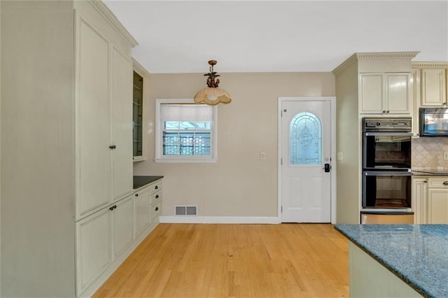 1618 Mason Mill Rd NE, Atlanta, GA 30329 - kitchen featuring double oven, tasteful backsplash, light wood finished floors, glass insert cabinets, and cream cabinets