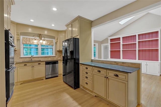 1618 Mason Mill Rd NE, Atlanta, GA 30329 - kitchen with black appliances, light wood-style floors, lofted ceiling, cream cabinets, and tasteful backsplash