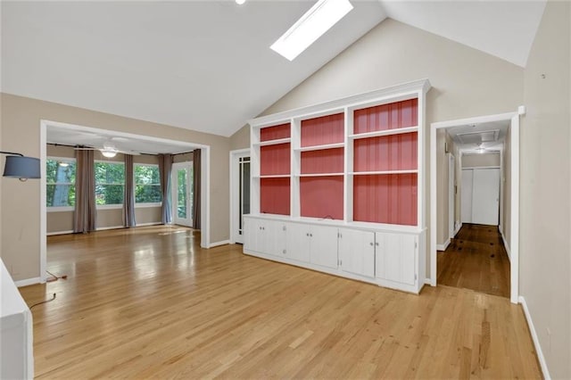 1618 Mason Mill Rd NE, Atlanta, GA 30329 - unfurnished living room with vaulted ceiling, light wood-style floors, a skylight, and attic access