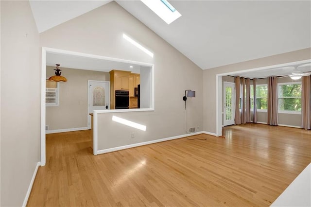 1618 Mason Mill Rd NE, Atlanta, GA 30329 - unfurnished living room with light wood-style floors, high vaulted ceiling, and a skylight