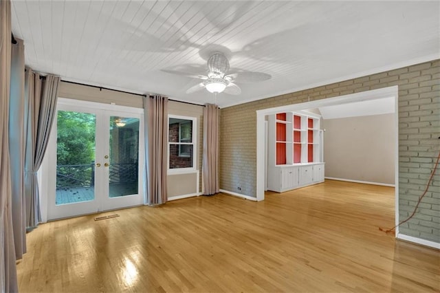 1618 Mason Mill Rd NE, Atlanta, GA 30329 - empty room with brick wall, french doors, a ceiling fan, and wood finished floors