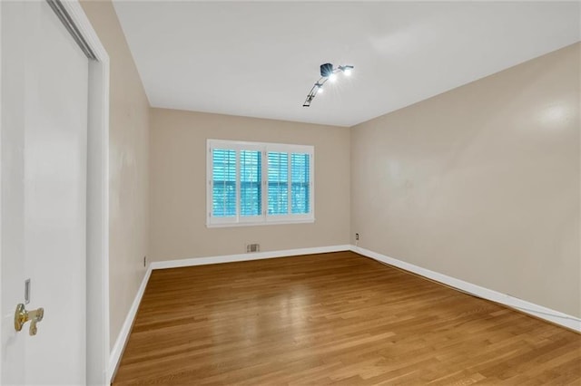 1618 Mason Mill Rd NE, Atlanta, GA 30329 - unfurnished room featuring wood finished floors and track lighting