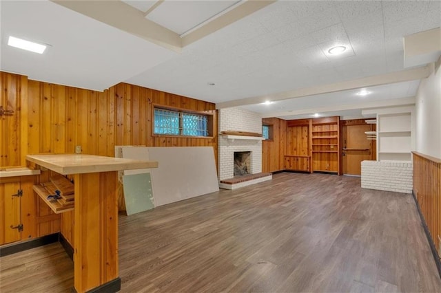 1618 Mason Mill Rd NE, Atlanta, GA 30329 - unfurnished living room featuring a fireplace, wood walls, and wood finished floors