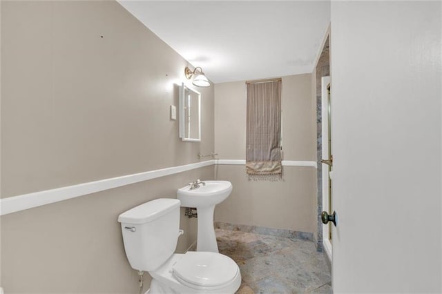 1618 Mason Mill Rd NE, Atlanta, GA 30329 - half bathroom featuring baseboards and stone finish floors