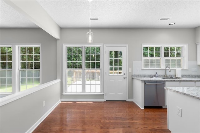 7000 Foxberry Ln, Roswell, GA 30075 - kitchen with dishwasher, white cabinetry, a textured ceiling, dark wood-style floors, and light stone countertops