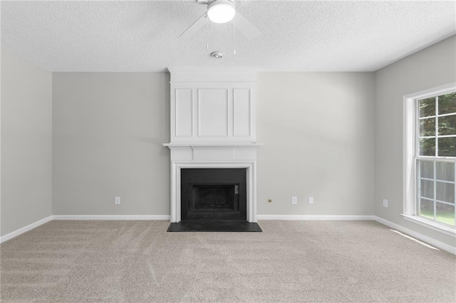 7000 Foxberry Ln, Roswell, GA 30075 - unfurnished living room featuring carpet flooring, a textured ceiling, a ceiling fan, and a large fireplace