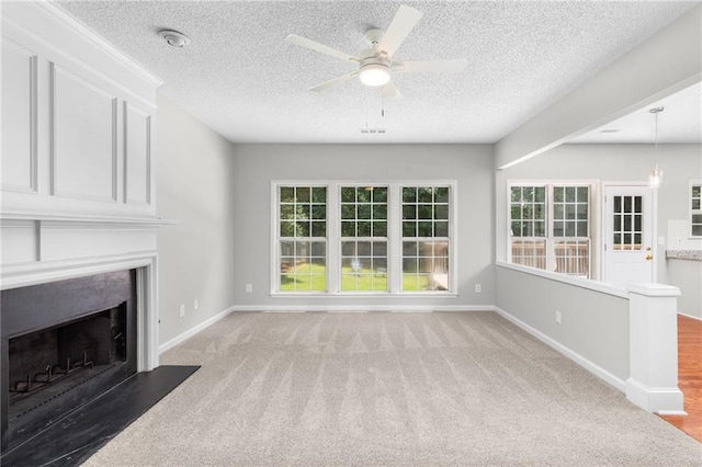 7000 Foxberry Ln, Roswell, GA 30075 - unfurnished living room featuring ceiling fan, carpet flooring, a premium fireplace, and a textured ceiling