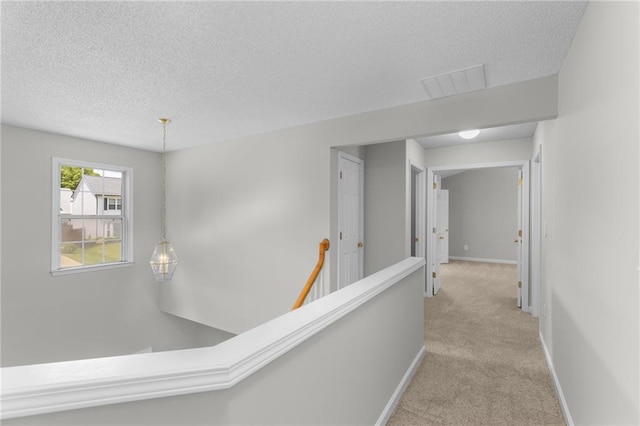 7000 Foxberry Ln, Roswell, GA 30075 - hallway with a textured ceiling, an upstairs landing, and carpet floors