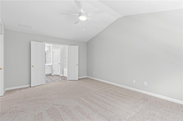 7000 Foxberry Ln, Roswell, GA 30075 - unfurnished bedroom featuring light carpet, vaulted ceiling, ensuite bath, and ceiling fan