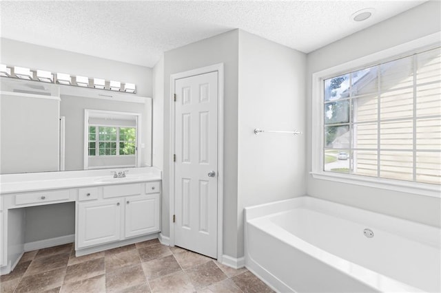 7000 Foxberry Ln, Roswell, GA 30075 - bathroom with vanity, a garden tub, and a textured ceiling