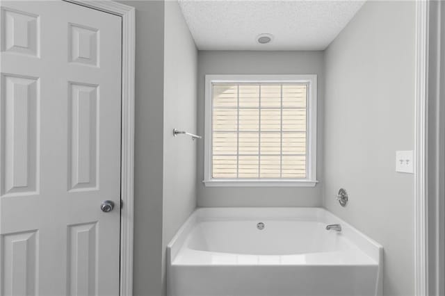 7000 Foxberry Ln, Roswell, GA 30075 - bathroom with a bath, a textured ceiling, and plenty of natural light